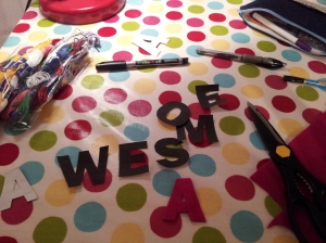 Cutting out the letters in paper then felt
